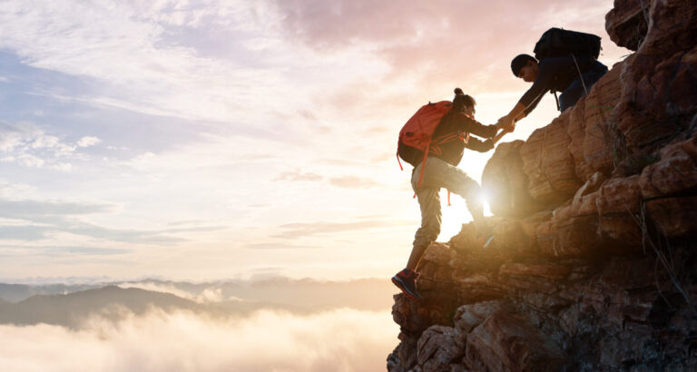 Group of happy hiker jumping on the hill